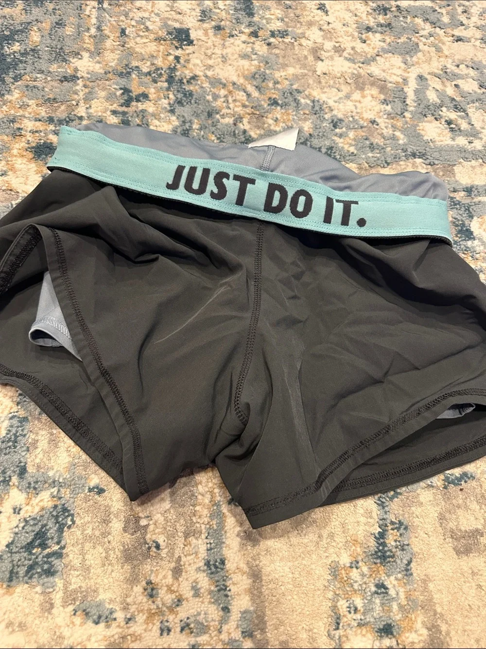 Nike Women's Black Athletic Shorts with Teal Swoosh